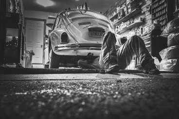 Person working under classic car