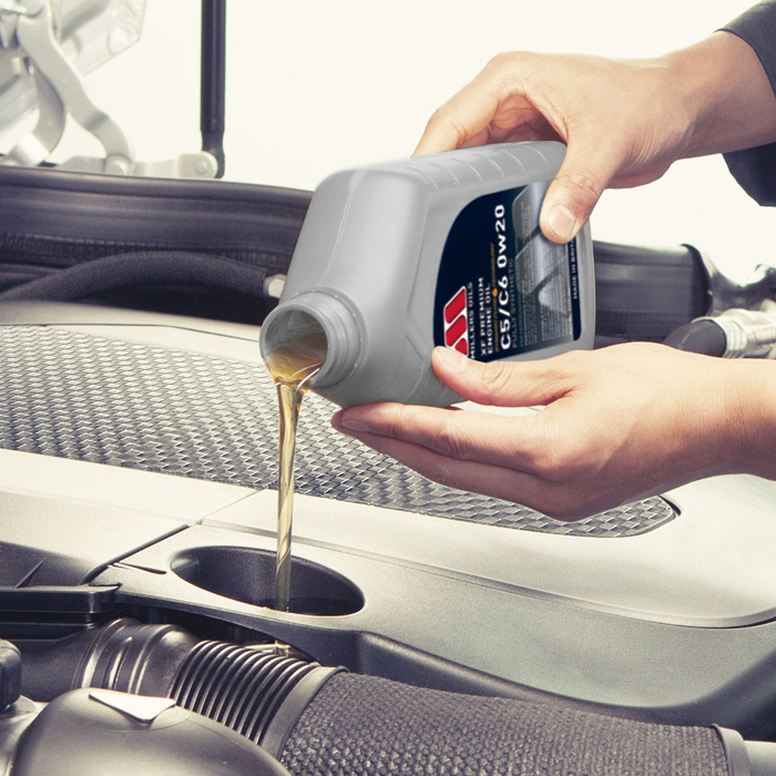 Photo of XF Premium being poured into a car engine