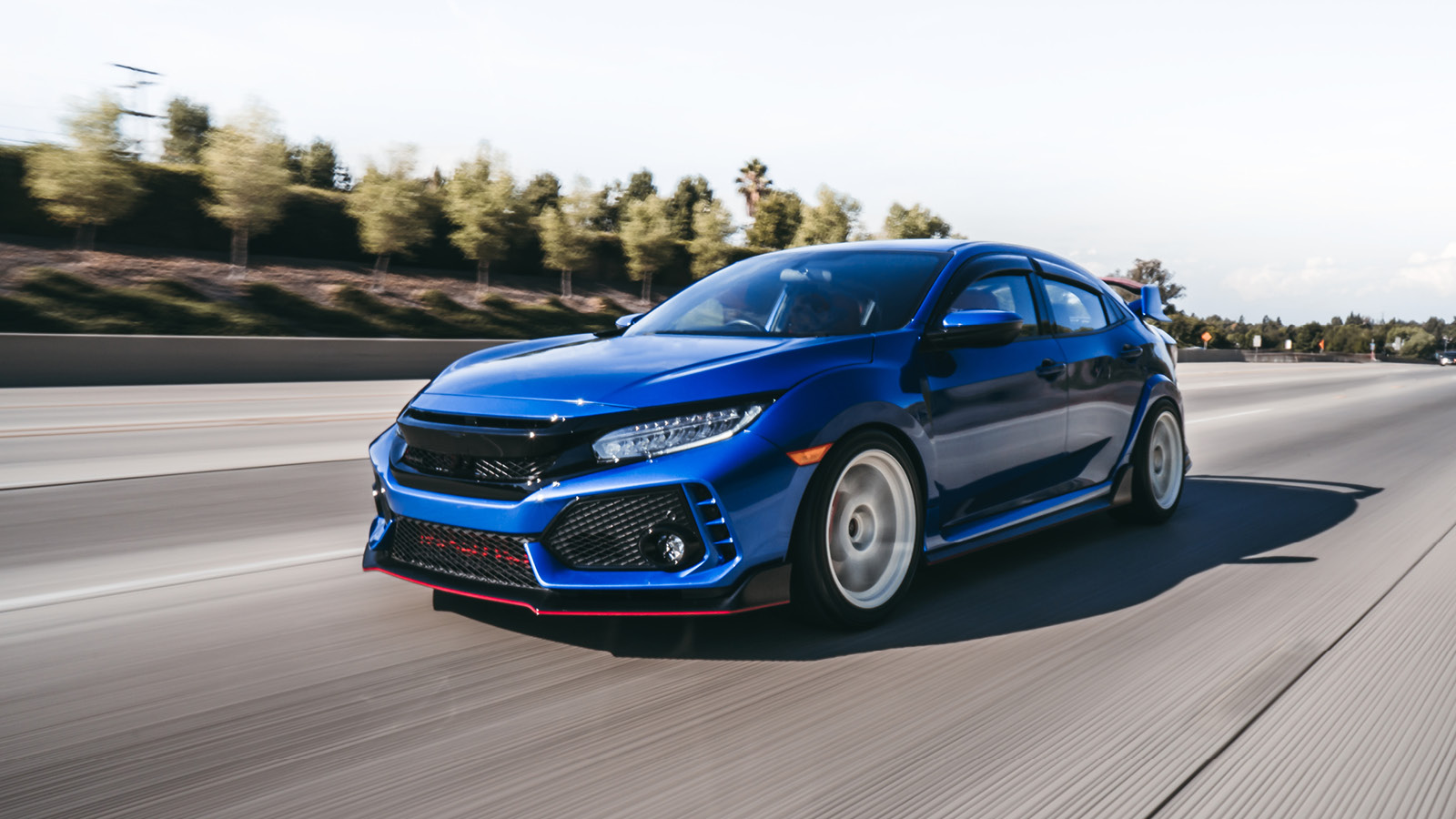 Photo of a blue car on a road